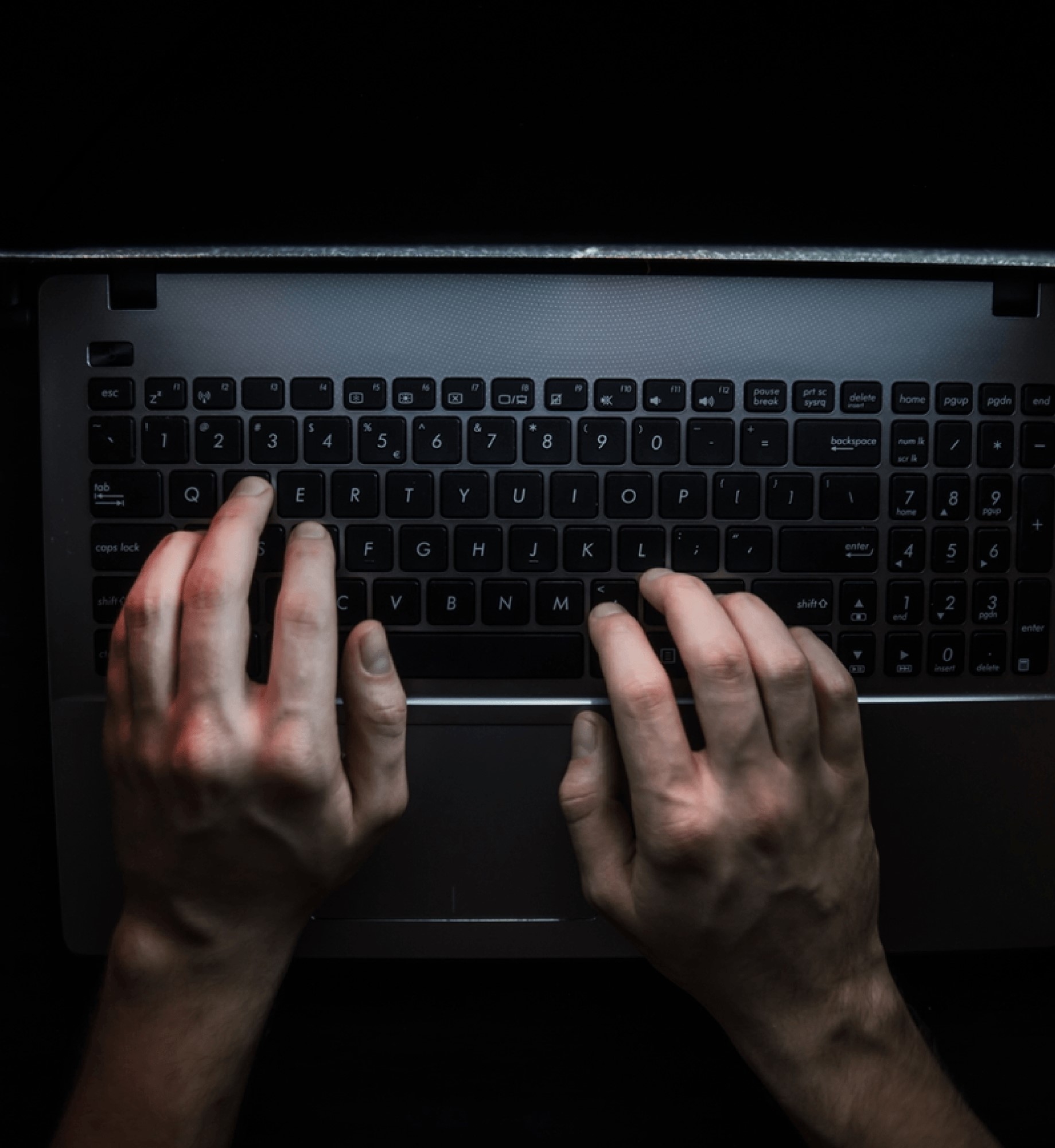 Hands resting on a laptop