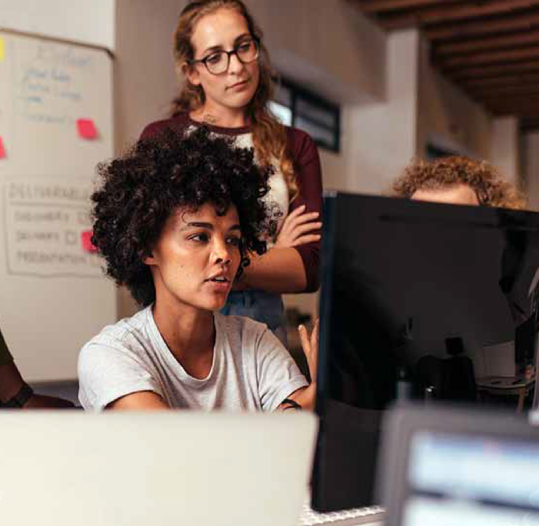 Team of women collaborating at desktop